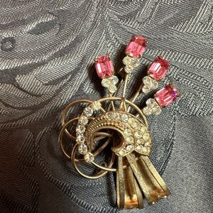 Gold brooch with pink and clear rhinestones.